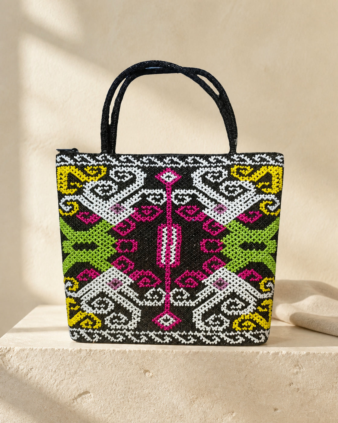 Amira beaded tote on limestone in soft morning light